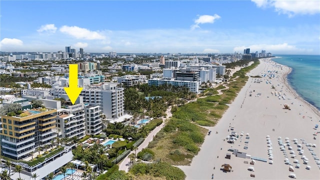 aerial view with a water view and a beach view