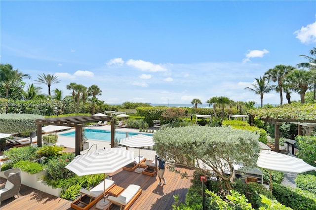 view of swimming pool featuring a deck and a pergola