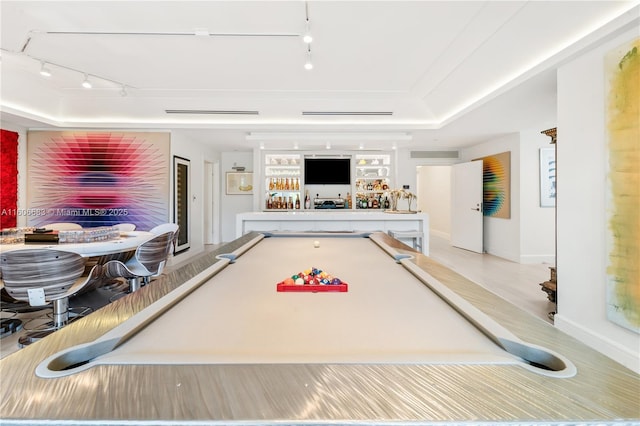 recreation room with indoor bar, rail lighting, light wood-type flooring, a raised ceiling, and billiards