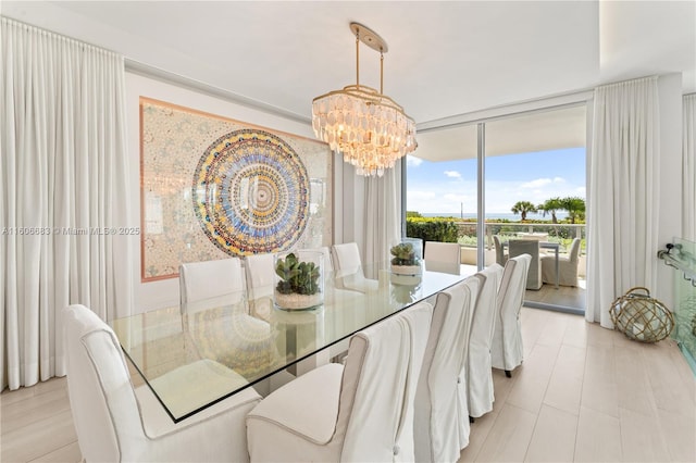 dining room featuring a chandelier and expansive windows