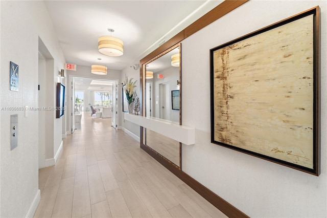 hallway with light hardwood / wood-style floors