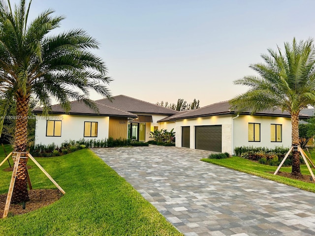 12231 SW 2nd St, Plantation, FL 33325 - view of front of house with a garage, decorative driveway, a front lawn, and stucco siding