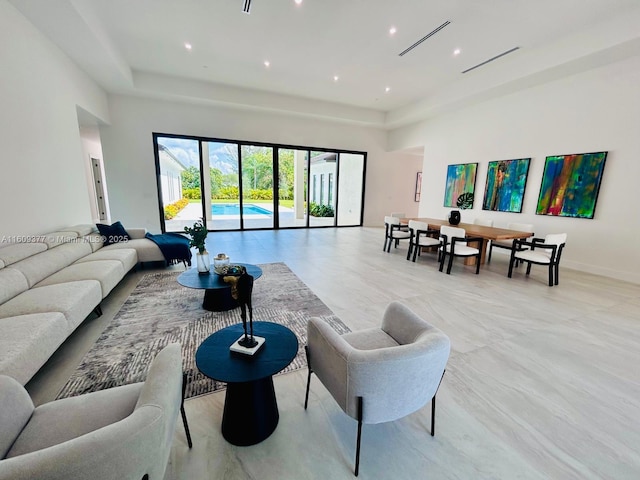 12231 SW 2nd St, Plantation, FL 33325 - living area featuring a raised ceiling, a towering ceiling, and baseboards