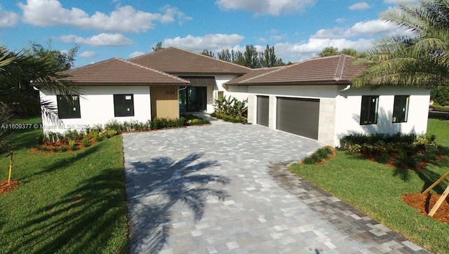 view of front of property with a front yard and a garage