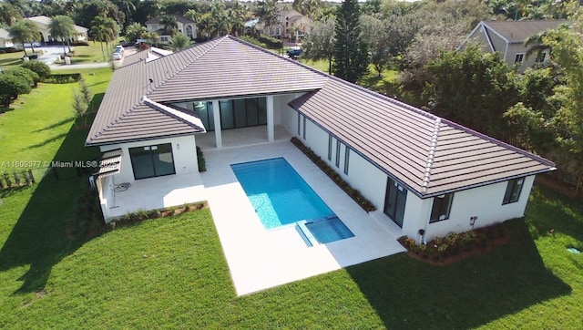 back of property featuring a yard and a patio