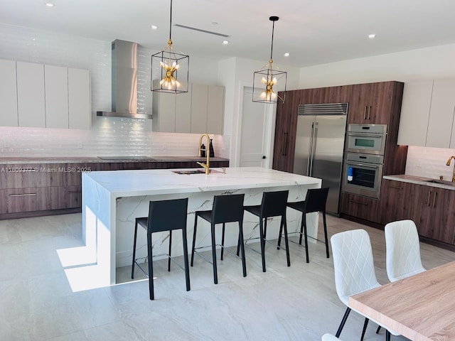 12231 SW 2nd St, Plantation, FL 33325 - kitchen featuring modern cabinets, wall chimney exhaust hood, appliances with stainless steel finishes, a sink, and backsplash
