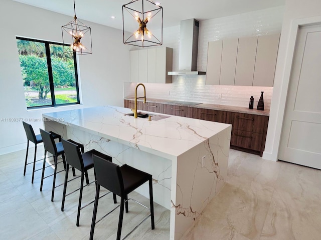 12231 SW 2nd St, Plantation, FL 33325 - kitchen featuring modern cabinets, wall chimney range hood, a sink, decorative backsplash, and an island with sink