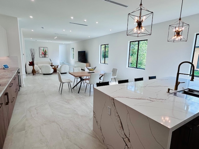 12231 SW 2nd St, Plantation, FL 33325 - kitchen featuring modern cabinets, light marble finish floors, a sink, recessed lighting, and pendant lighting