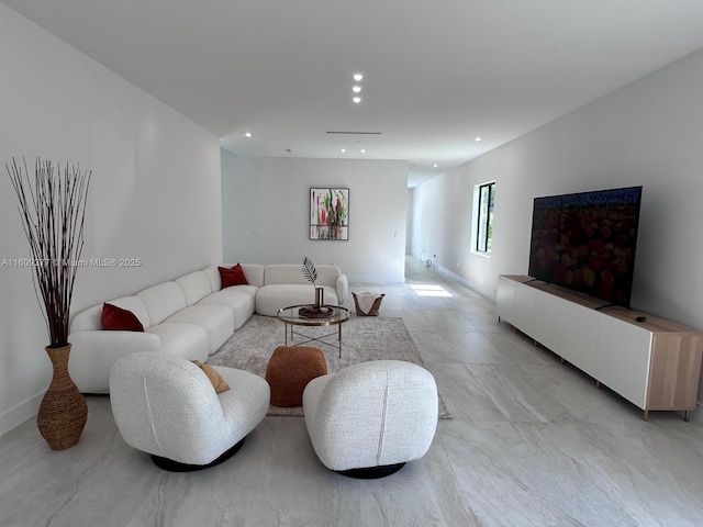 living area featuring baseboards and recessed lighting