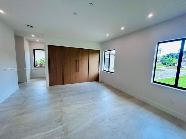 12231 SW 2nd St, Plantation, FL 33325 - unfurnished bedroom with a closet, baseboards, multiple windows, recessed lighting, and finished concrete flooring