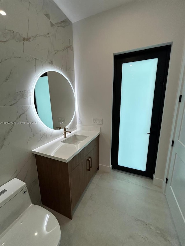 bathroom featuring vanity and toilet