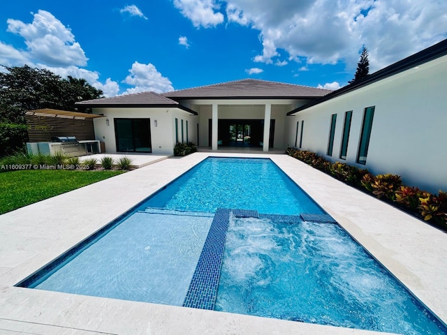 12231 SW 2nd St, Plantation, FL 33325 - view of swimming pool with a patio, a pool with connected hot tub, and exterior kitchen