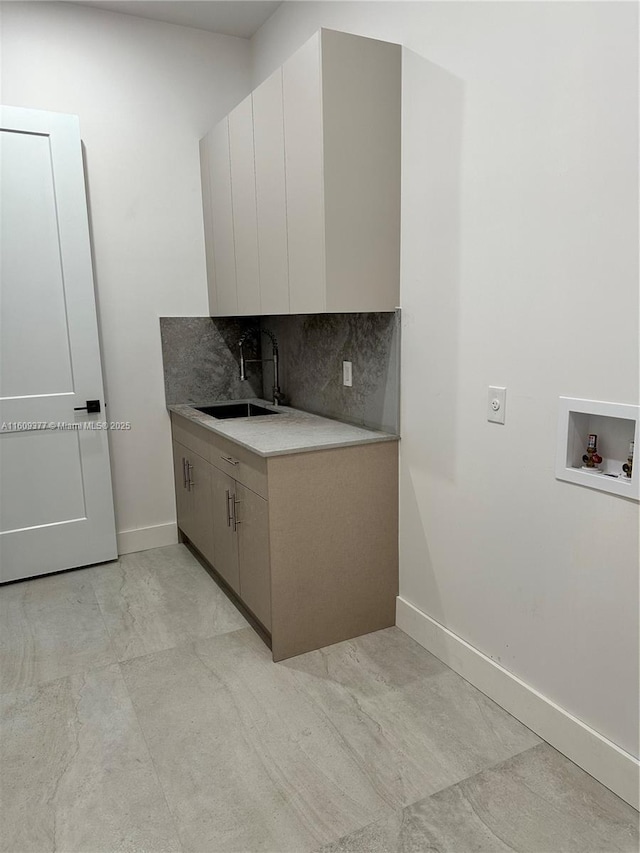 kitchen featuring backsplash and sink