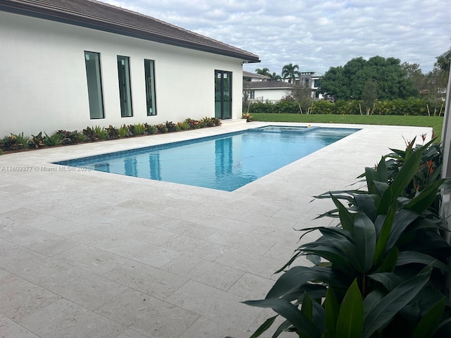 view of swimming pool featuring a patio area