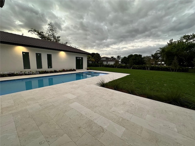 view of swimming pool with a yard and a patio