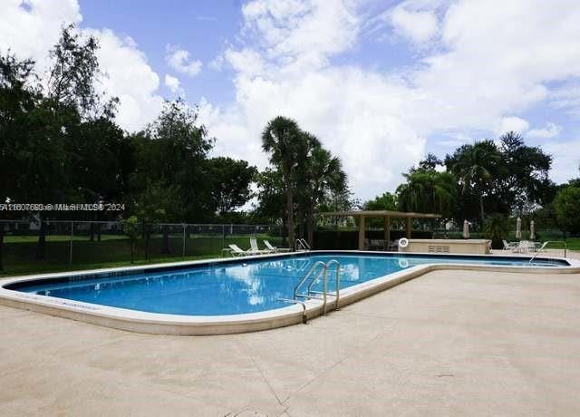 800 NE 195th St Unit 619, Miami, FL 33179 - community pool featuring a patio area and fence