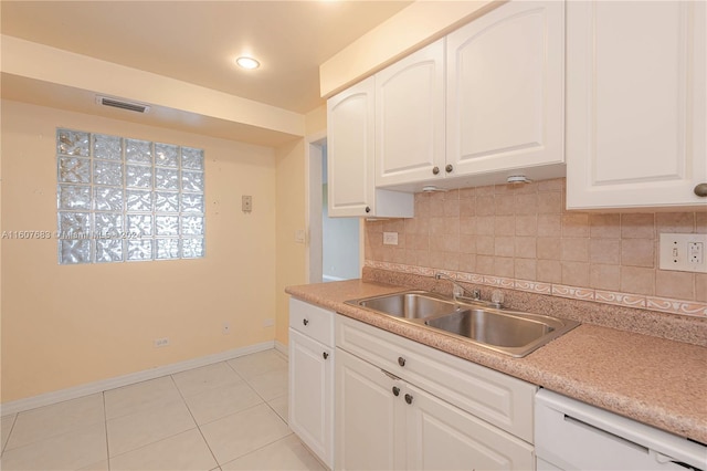 kitchen featuring light tile patterned floors, backsplash, white cabinetry, dishwasher, and sink