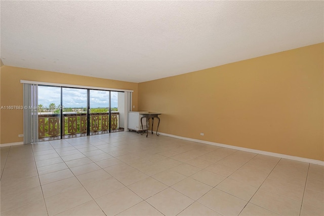 800 NE 195th St Unit 619, Miami, FL 33179 - unfurnished room featuring baseboards, a textured ceiling, and light tile patterned floors