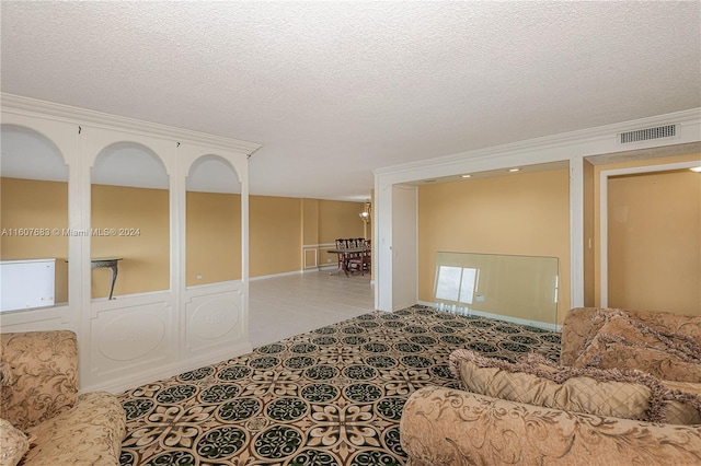 tiled living room with a textured ceiling