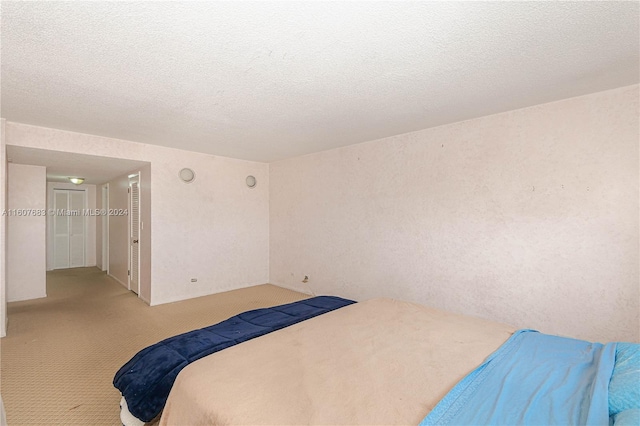 carpeted bedroom with a textured ceiling