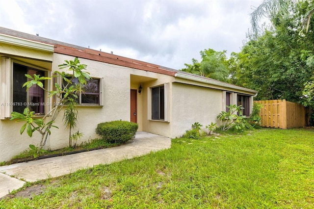 rear view of property featuring a yard