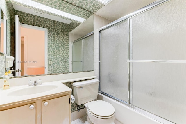 full bathroom with tile patterned floors, vanity, toilet, and shower / bath combination with glass door