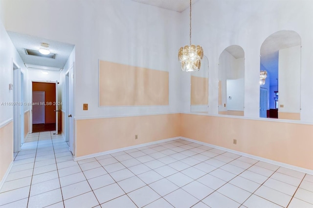 spare room with light tile patterned floors and a textured ceiling