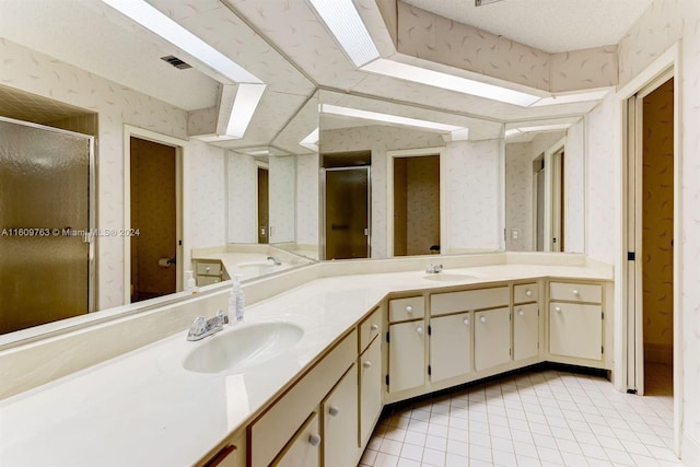 bathroom with tile patterned flooring, vanity, and a shower with shower door