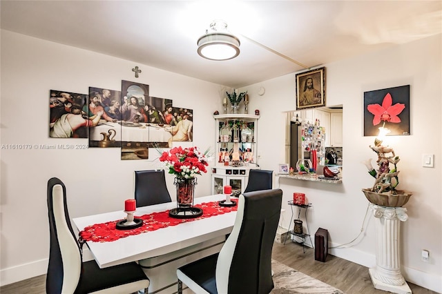 dining space featuring hardwood / wood-style floors