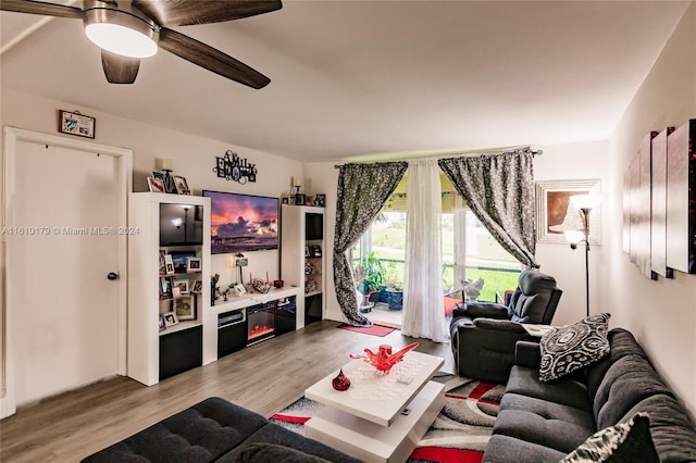 living room featuring ceiling fan and light hardwood / wood-style flooring