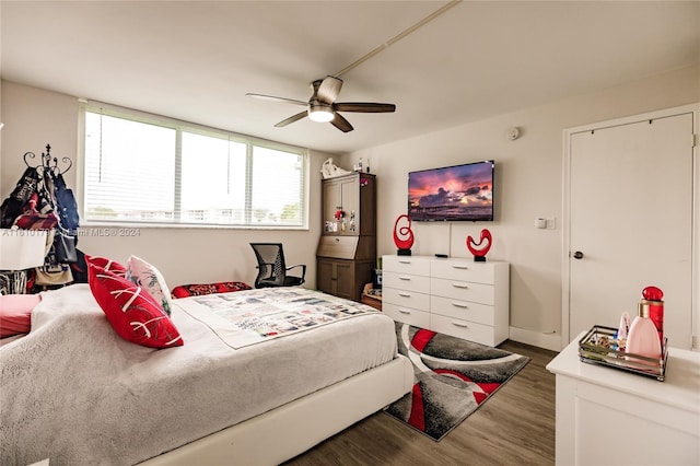 bedroom with ceiling fan and dark wood-type flooring