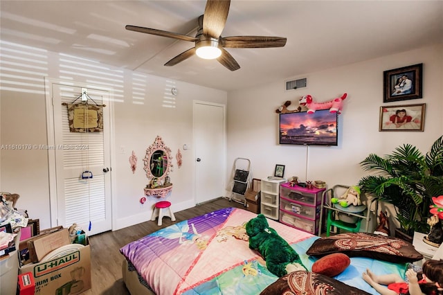 bedroom with ceiling fan and dark hardwood / wood-style floors