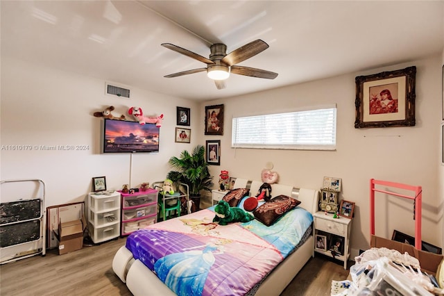 bedroom with ceiling fan and hardwood / wood-style floors