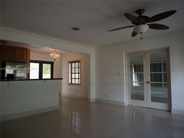 unfurnished room featuring french doors, ceiling fan with notable chandelier, light tile patterned floors, and crown molding