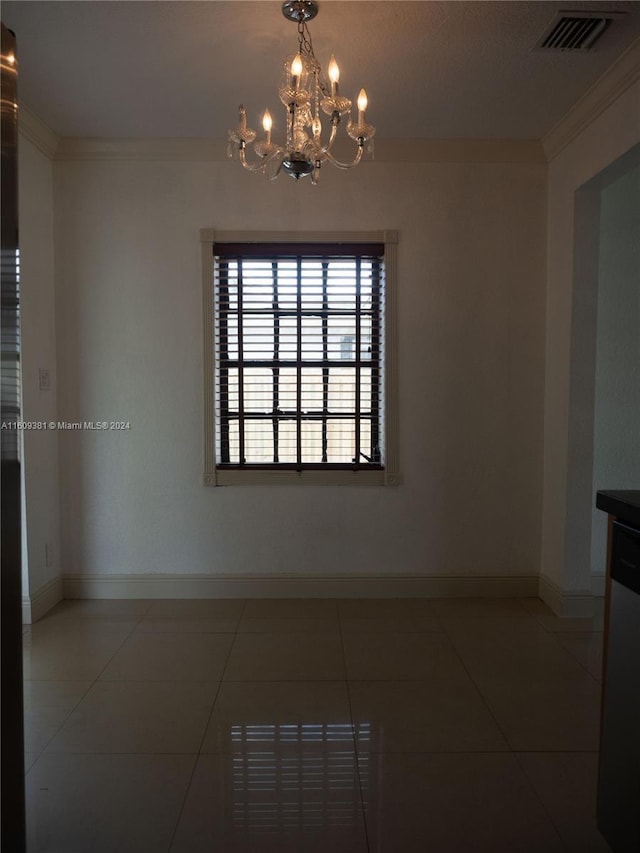 tiled empty room with crown molding and a chandelier