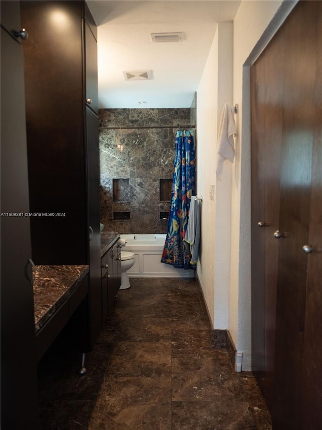 full bathroom featuring shower / bath combo with shower curtain, vanity, and toilet