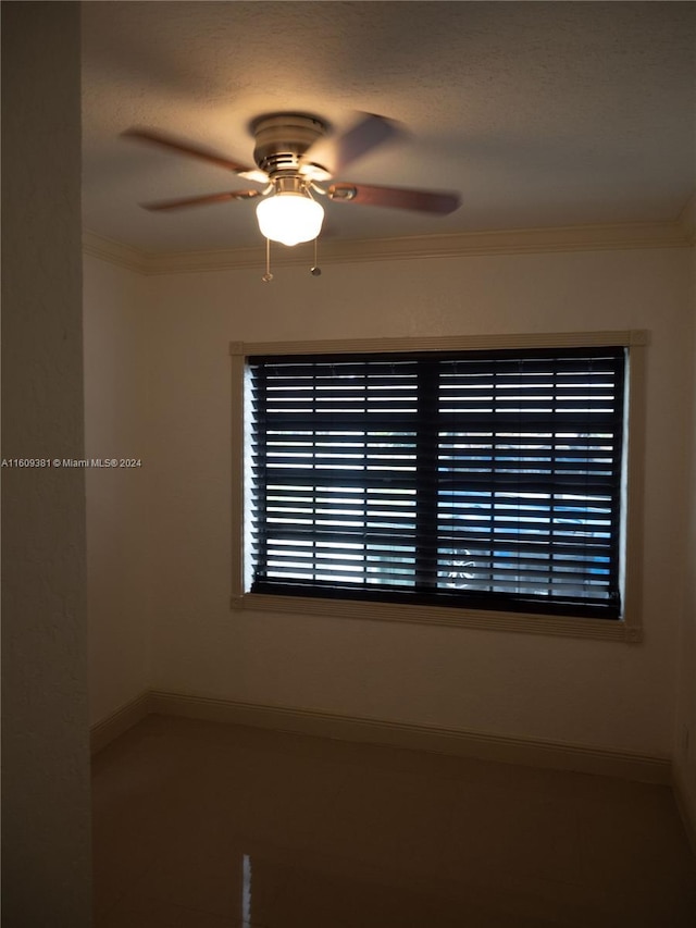 spare room with ceiling fan, a textured ceiling, and ornamental molding