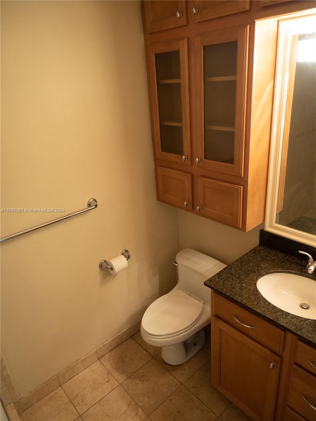 bathroom featuring tile patterned floors, vanity, and toilet