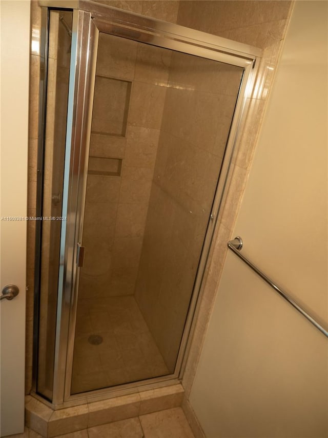 bathroom featuring tile patterned floors and a shower with door