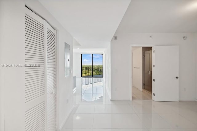 corridor featuring light tile patterned floors