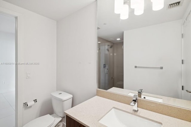 bathroom with walk in shower, vanity, and toilet