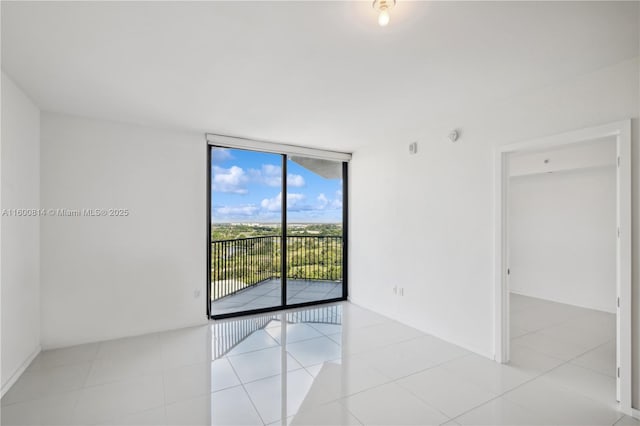 tiled spare room with expansive windows