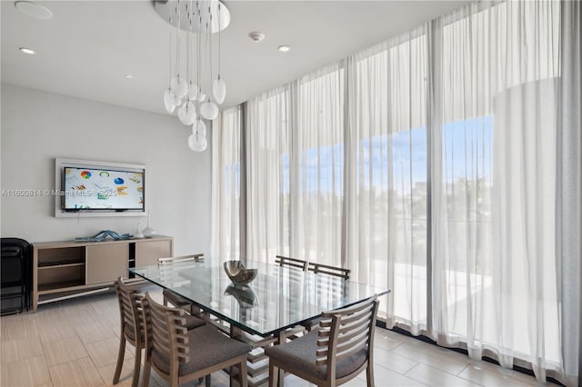 tiled dining room with a notable chandelier