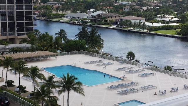 view of swimming pool featuring a water view