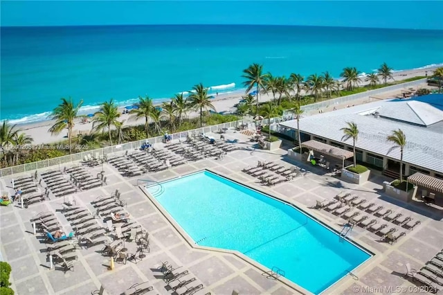 view of swimming pool featuring a patio area and a water view