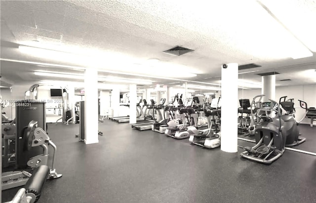 gym with a textured ceiling