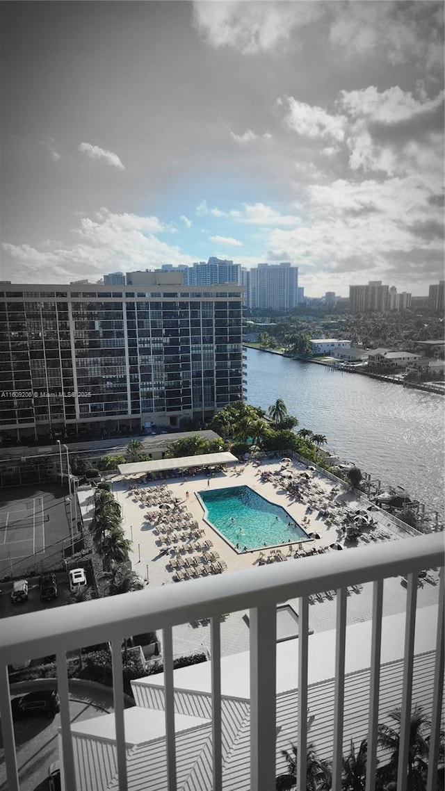 view of swimming pool featuring a water view