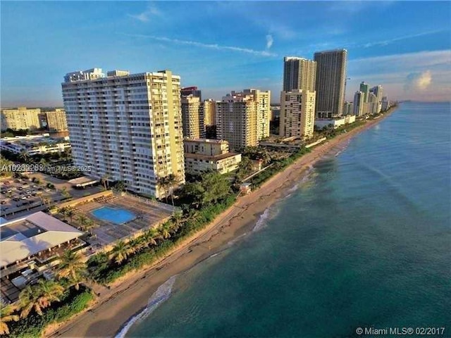 birds eye view of property featuring a view of the beach and a water view