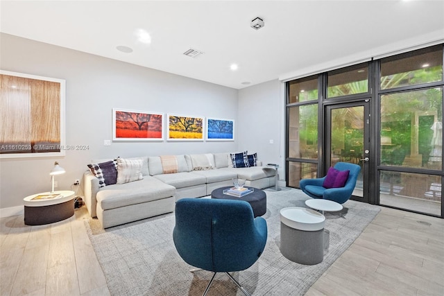 living room with light hardwood / wood-style floors and expansive windows