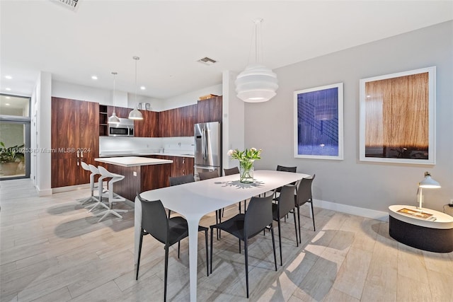 dining space with light wood-type flooring